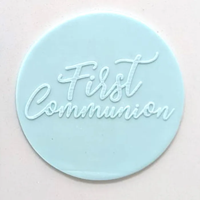 a blue fondant plaque embossed with "First Communion"