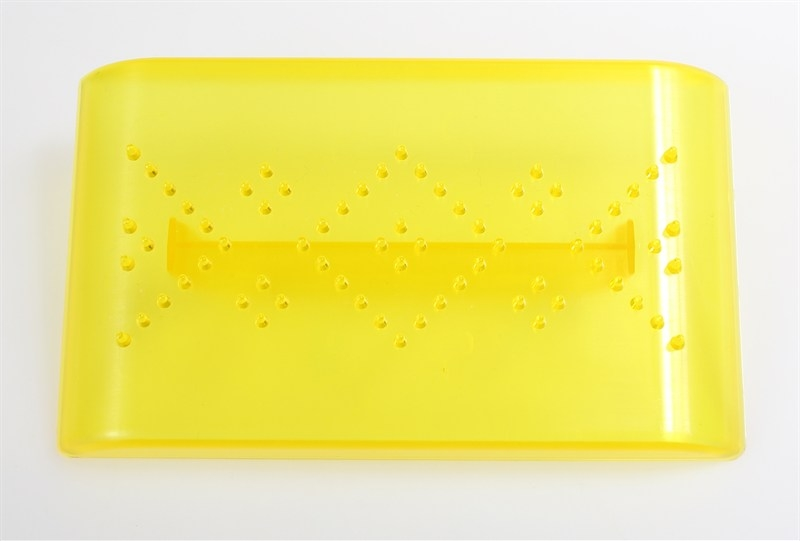 A bright yellow translucent plastic rectangular tray with a handle and small raised dot details, photographed on a plain white background.