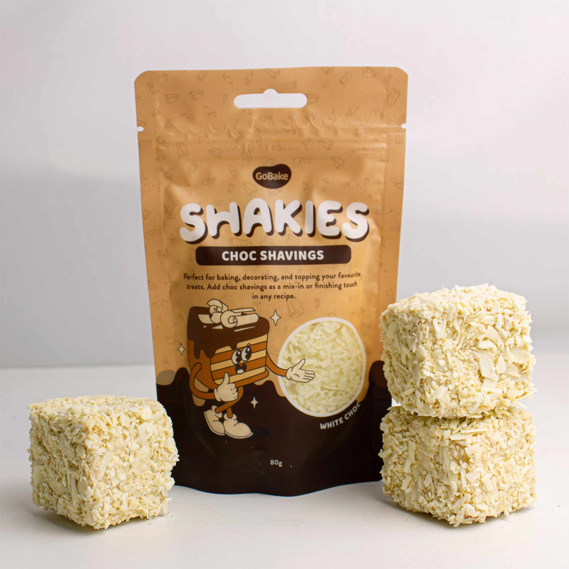 White chocolate shavings with examples of finished cakes