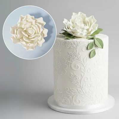 White cake with floral icing magnolia flower decoration and close-up picture.