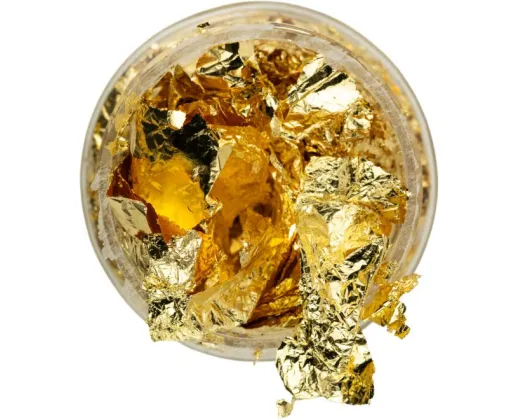 Open jar of gold decorating leaf