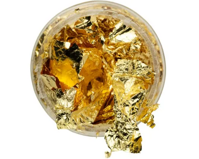 Open jar of gold decorating leaf
