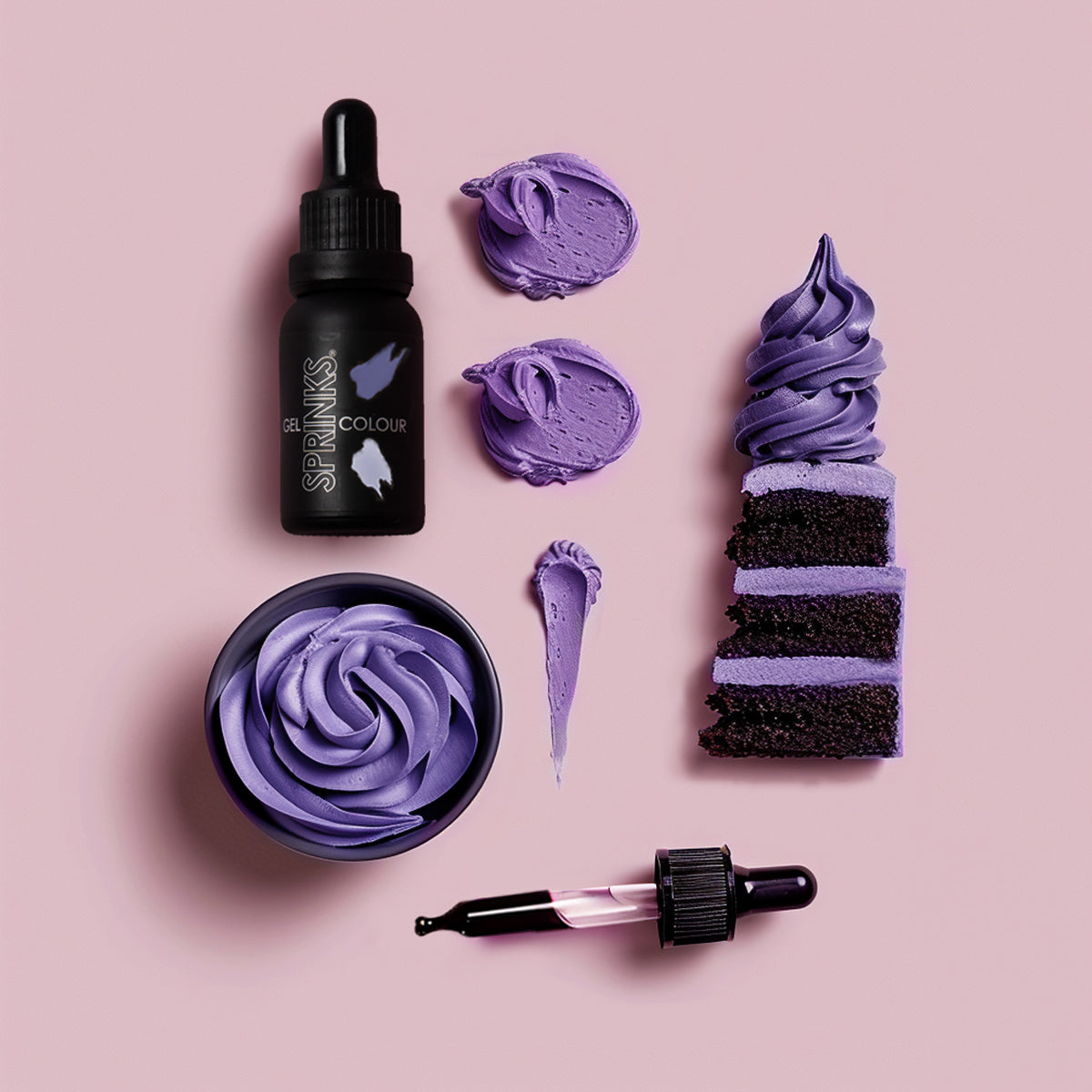Purple cake batter with Sprinks Colour bottle and tools on a pink background