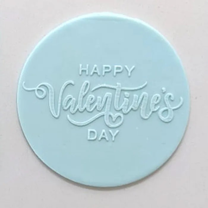 icing plaque made of teal fondant. Embossed with Happy Valentine's Day