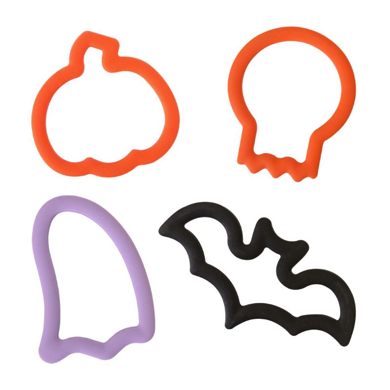Set of Halloween-themed cookie cutters including a pumpkin, skull, ghost, and bat on a white background.
