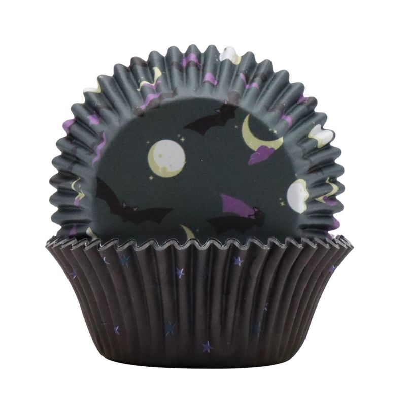 Black cupcake liner with a Halloween night themed design on a white background