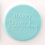 A blue fondant plaque embossed with Happy Birthday