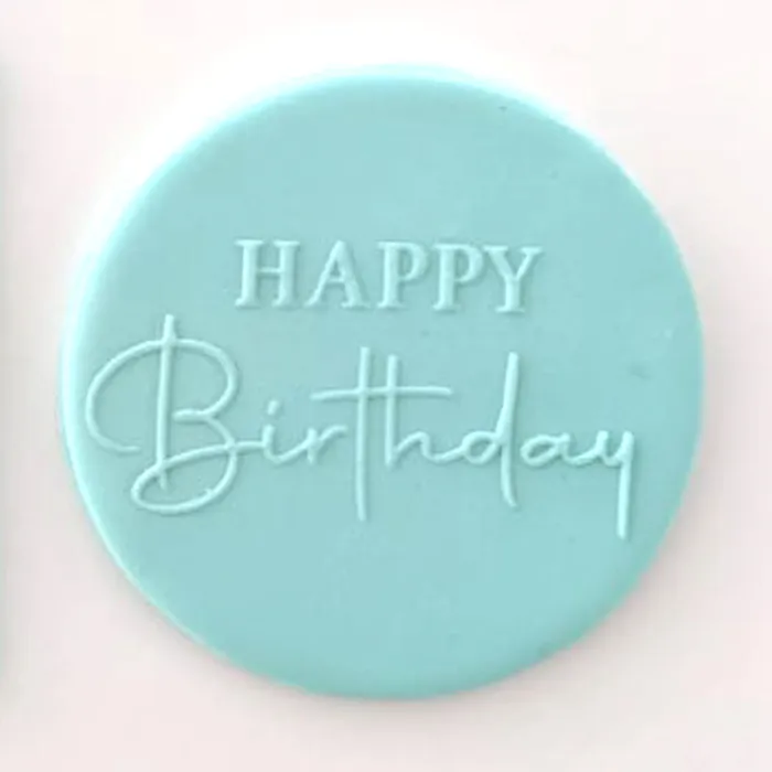 A blue fondant plaque embossed with Happy Birthday