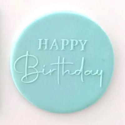 A blue fondant plaque embossed with Happy Birthday