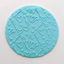 a blue fondant plaque with an embossed pattern of hearts