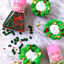 Cupcakes decorated with sprinkles for Christmas, alongside sprinkle jars