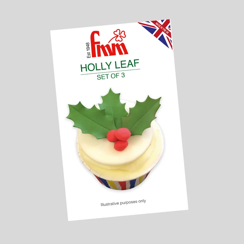 A product card for 'Fmm Holly Leaf Set of 3' showing a cupcake decorated with a green holly leaf and red berries, on a light gray background.