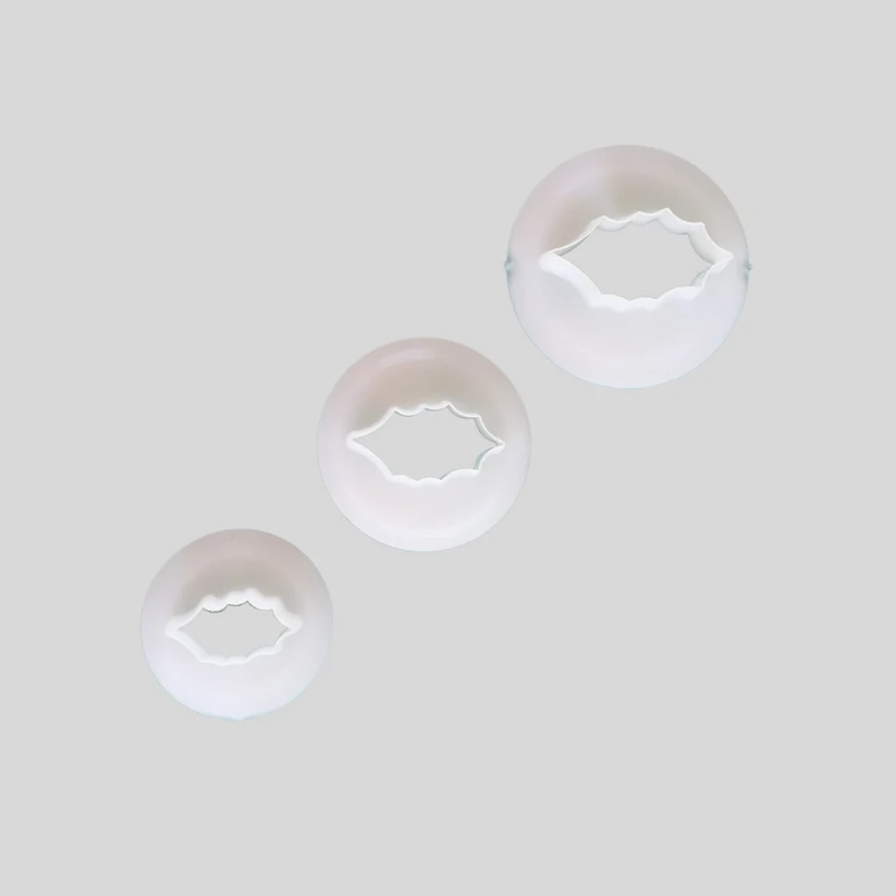 Three graduated Holly leaf gumpaste icing cutters. In white plastic