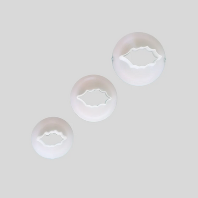 Three graduated Holly leaf gumpaste icing cutters. In white plastic