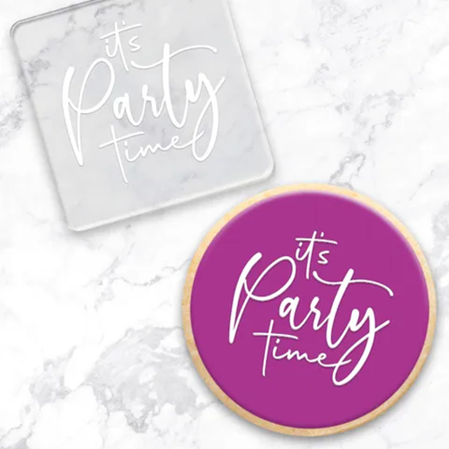 Clear acrylic debosser tool alongside a cookie made using it. It reads It's Party time
