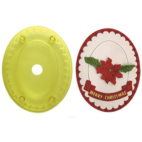 Yellow plastic icing cutter and red Christmas-themed decorative fondant cake topper, made using the plaque cutter on a white background