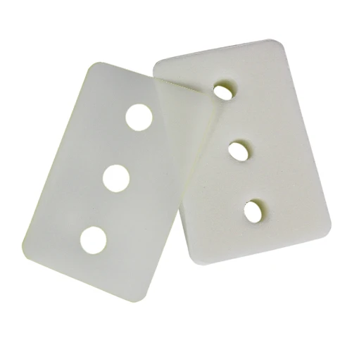 Two white rectangular foam pads pads with rounded corners and three circular holes, shown overlapping on a plain white background.