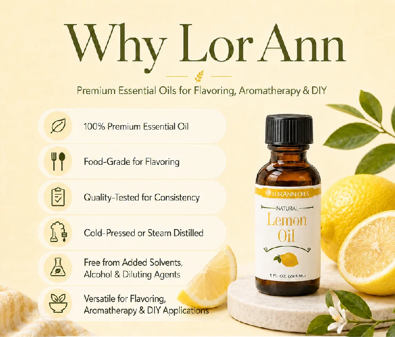 A bottle of LorAnn Natural Lemon Oil displayed on a light cream background with promotional text on the left and fresh lemon slices and leaves on the right. The bottle is amber glass with a black cap and a white label featuring yellow and green accents.