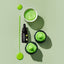 Green icing food colour including a bowl of icing, bottles, and cupcakes on a light green background