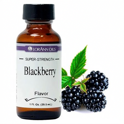 Lorann 1oz bottle of flavouring sitting alongside fresh blackberries