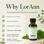 A bottle of LorAnn Peppermint Oil displayed on a light beige background with promotional text on the left and green leaves on the right. The bottle is amber glass with a black cap and a white label featuring green and black text.