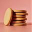Stack of round cookies on a pink background