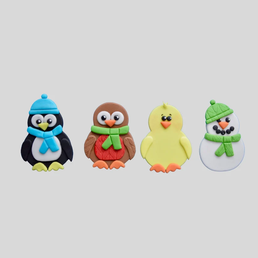 Fondant icing examples of penguin, owl, baby chick and snowman