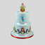 A pale blue cake with snowflakes,. On top is a birdhouse with an owl. Around the bottom tier are mummy and baby penguins. On the middle tier is a snowman