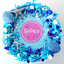 A cake decorated with seashells and mermaid pool party sprinkles in blue silver and white