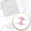 Clear acrylic debosser with 'Miss to Mrs' text . Alo0ngside a finished cookie with the same message, showcasing the tools use - on a marble surface