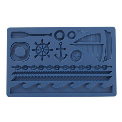 A blue rectangular silicone mold with nautical-themed cavities, including a ship's wheel, anchor, sailboat, rope, waves, and life preserver, on a plain white background.