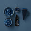 Blue-colored cake, cupcake, and bottle of Sprinks gel color on a blue background