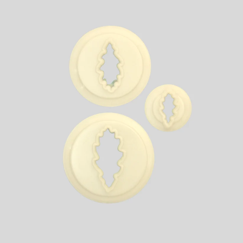 Three round cream-colored plastic  cutters in different sizes, shape dlike oak leaves, arranged on a solid light gray background.