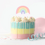 Colorful cake with a rainbow design on top against a white background
