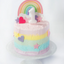 Colorful cake with rainbow, stars, and hearts on a white background