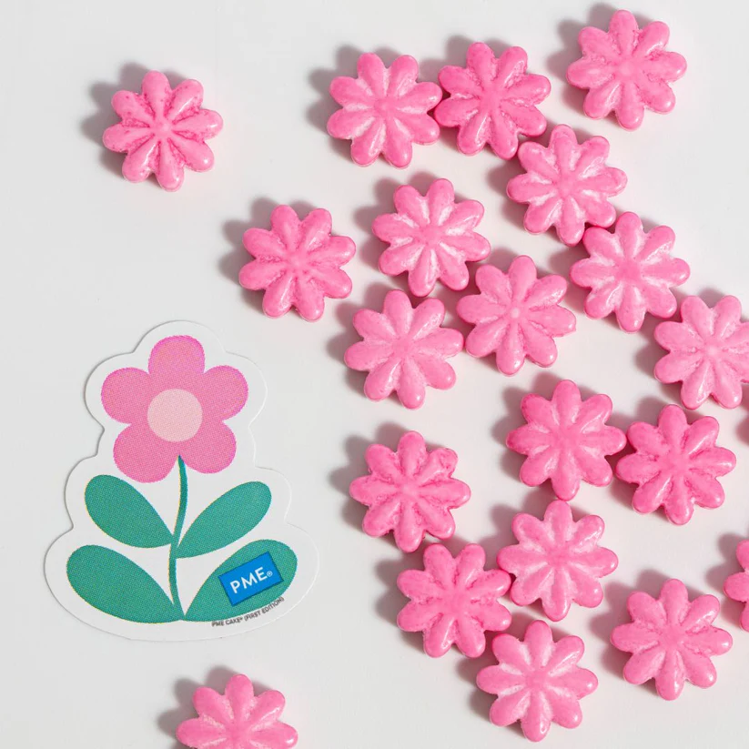 Pink flower-shaped cupcake candies with a PME logo on a white background