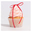 Cupcake with pink frosting and a red ribbon on a white background