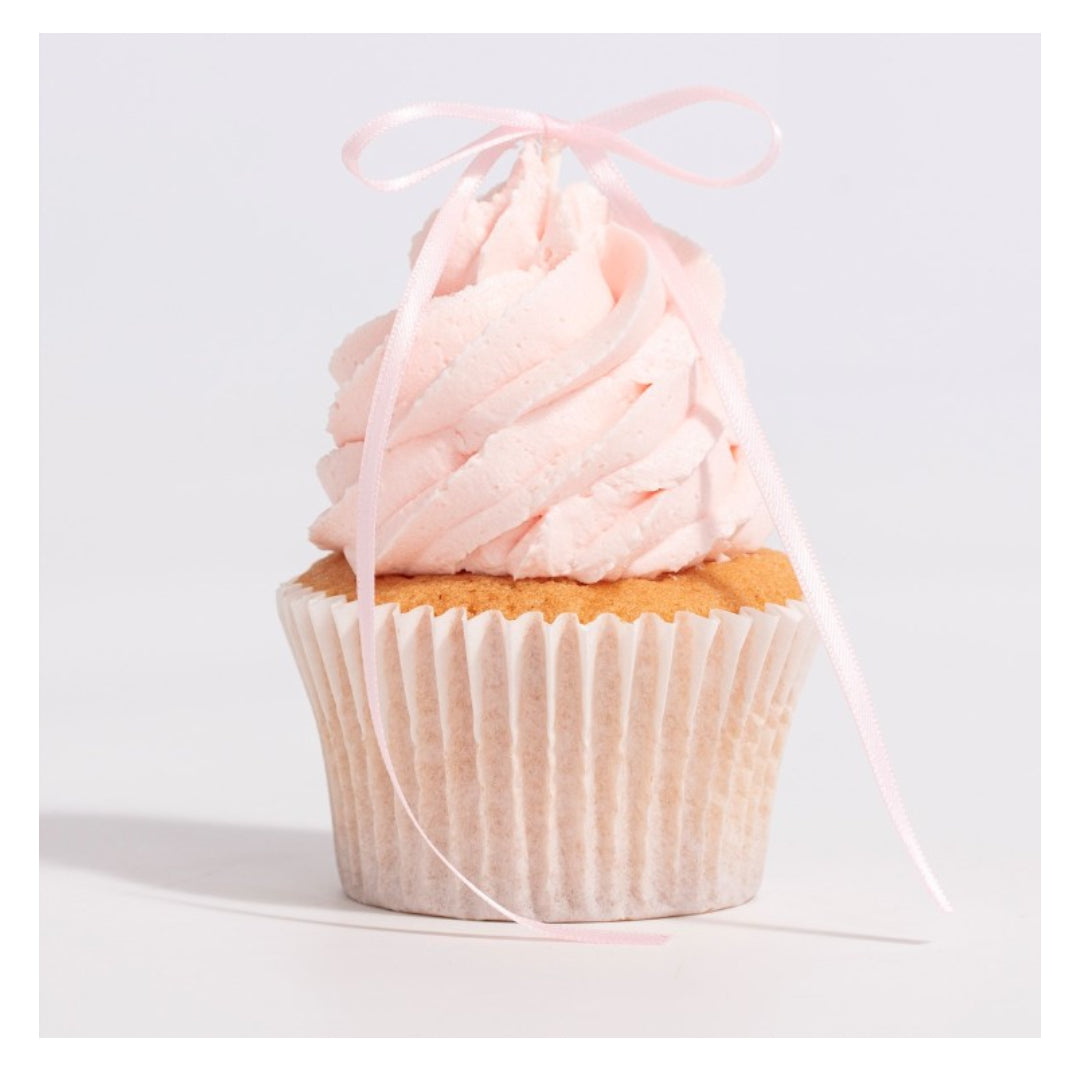 Cupcake with pink frosting and a pink ribbon on a light gray background