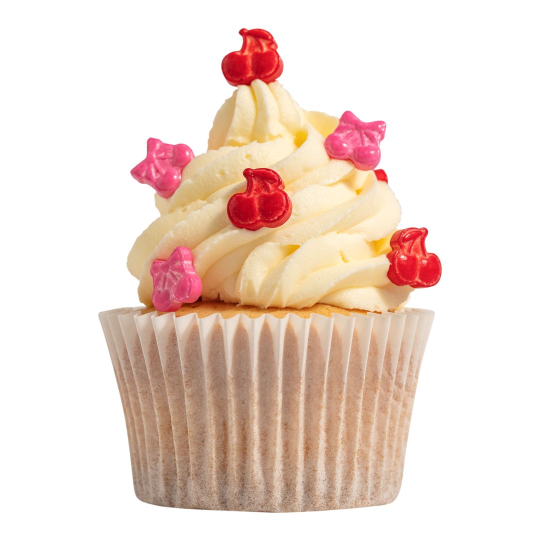 Cupcake with white frosting, red and pink cherry decorations on a white background