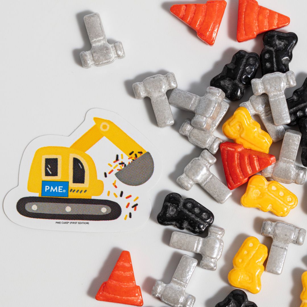 Construction-themed candy sprinkles with a die-cut sticker of an excavator on a white background