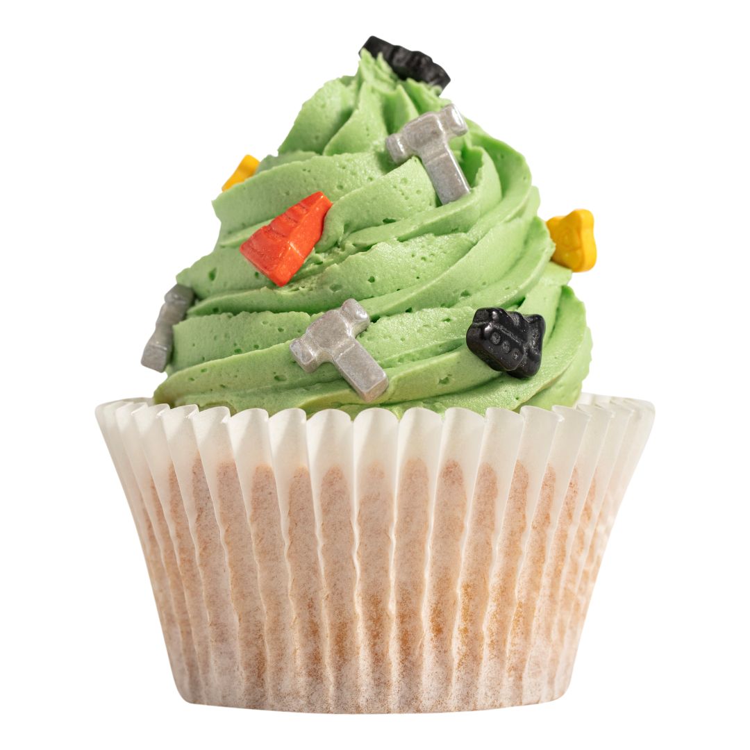 Green frosted cupcake with Construction-themed decorations on a white background