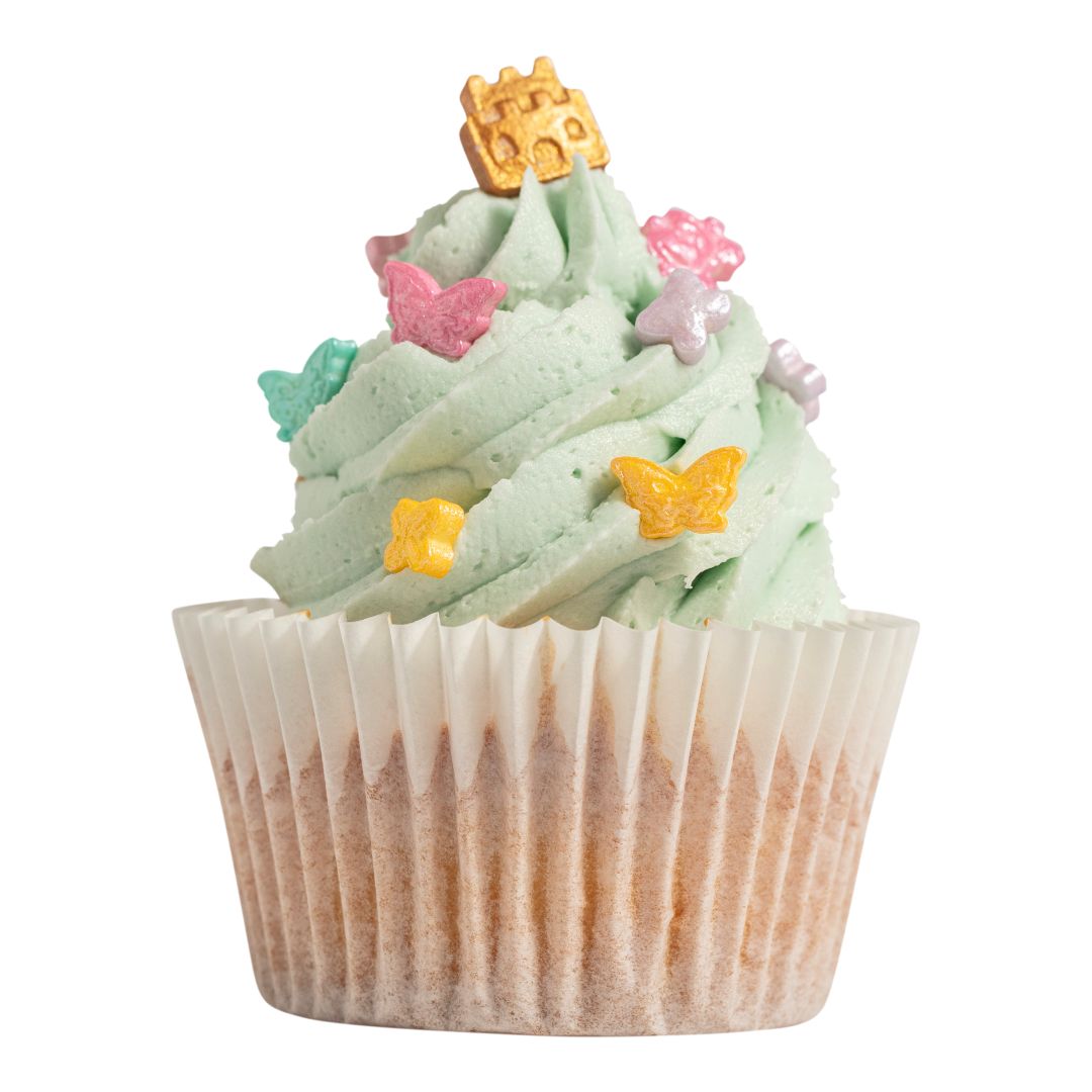 Decorative cupcake with green frosting, butterflies, and a gold crown on a white background