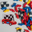 Colorful race car-themed sprinkles with a checkered flag and red car sticker on a white background.