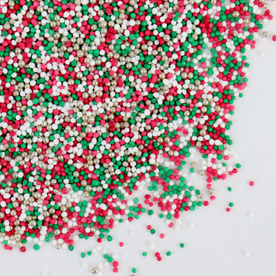 Colorful sprinkles in red, green, and white on a white background