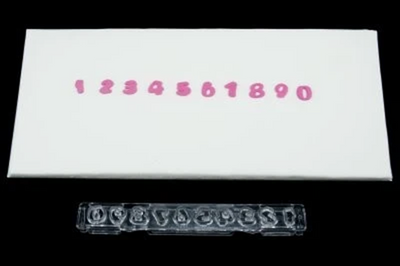 Small number plastic cutter with ejector. Alongside fondant icing examples made with the cutter