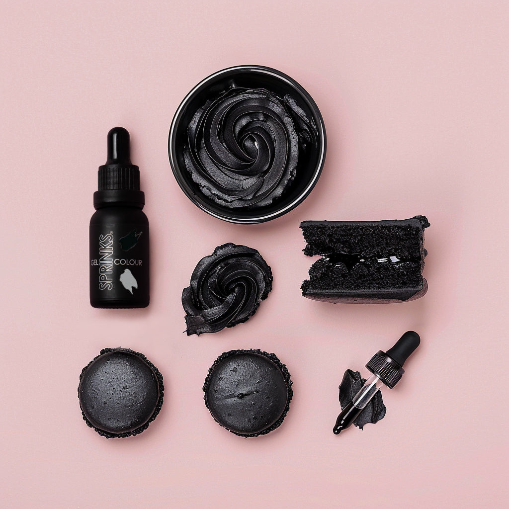 Black Sprinks food colouring including a bottle, bowl, and applicators on a pink background