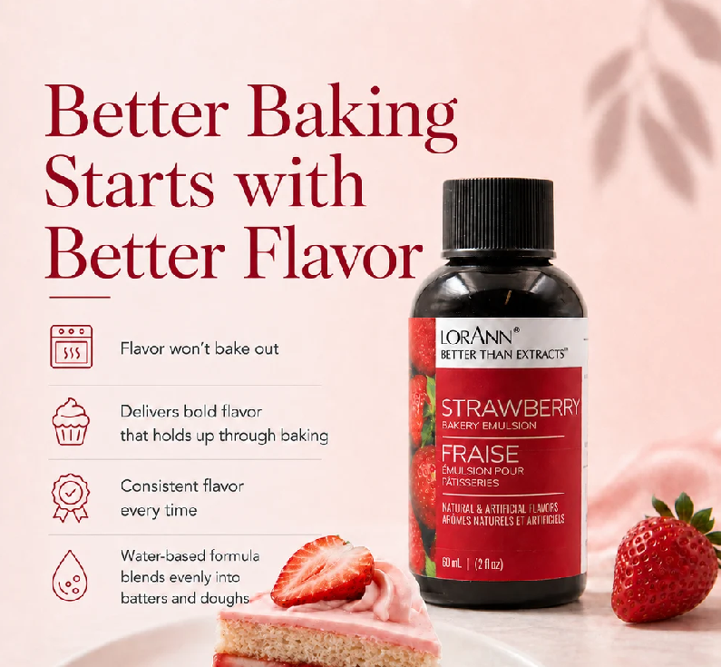 A bottle of Lorann Better Than Extracts Strawberry Baking Flavor Emulsion is shown on a soft pink background with promotional text and a slice of strawberry cake and a whole strawberry. The bottle is dark amber with a black cap and a red label.