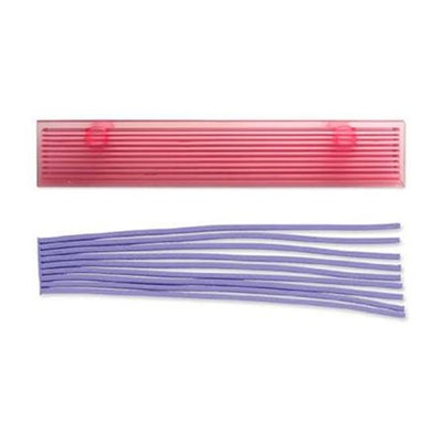A pink rectangular plastic strip cutter tool with two small circular handles shown above a bundle of purple fondant strip pieces, on a plain white background.