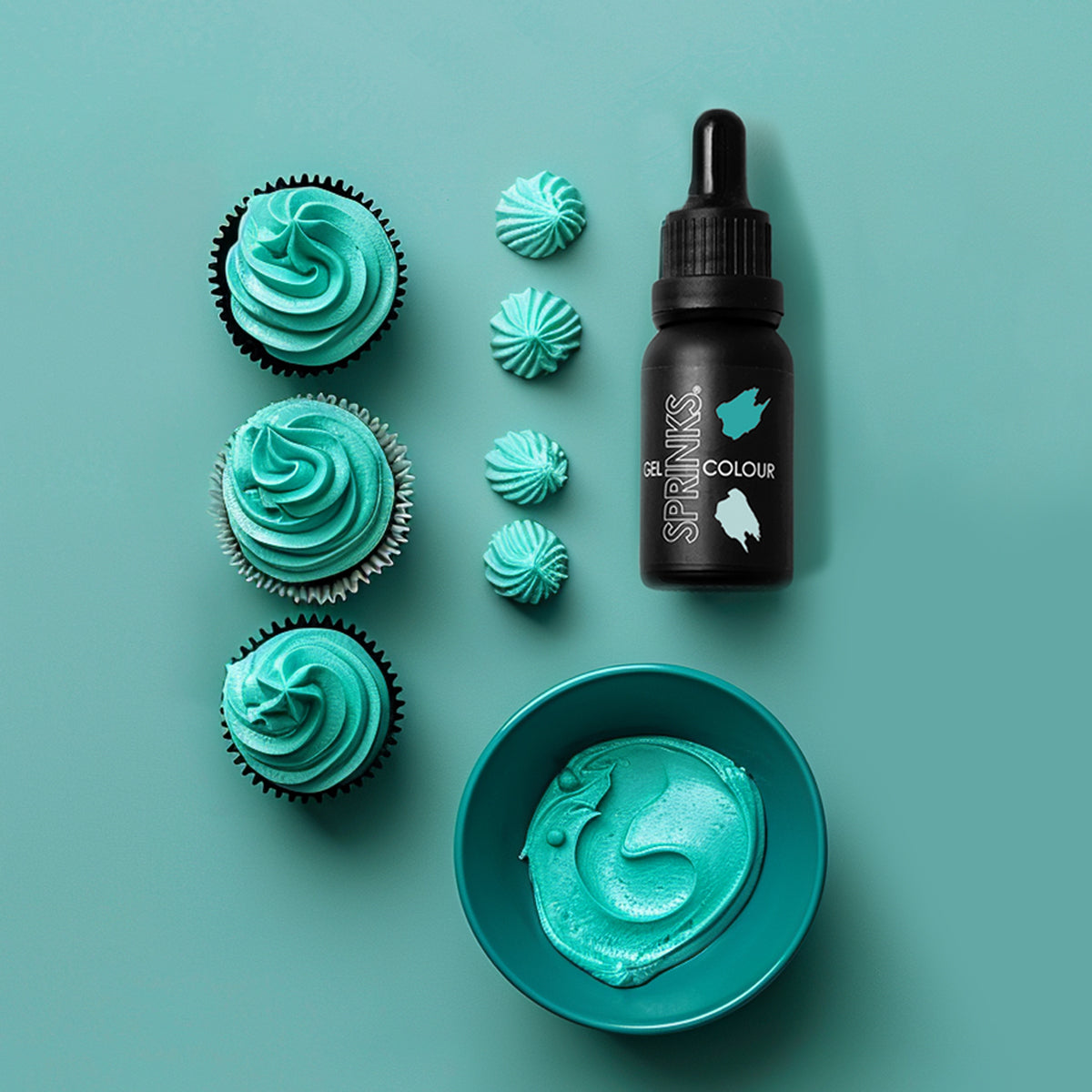 Cupcakes with teal frosting, a bottle of teal colorant, and a bowl of teal frosting on a teal background.