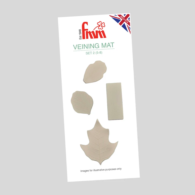A Fmm Veining Mat Set 2 (5-8) package containing four beige-colored veining mat pieces, including leaf and rectangular shapes, shown against a solid gray background.